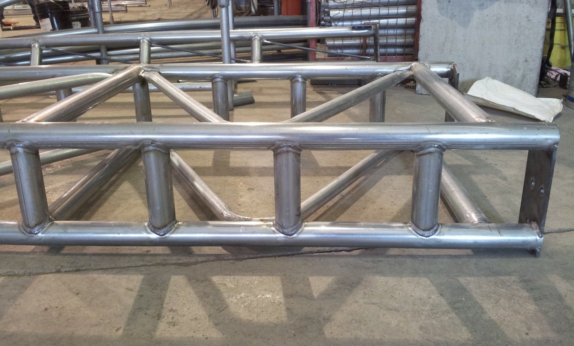 A metal structure is sitting on a cement floor