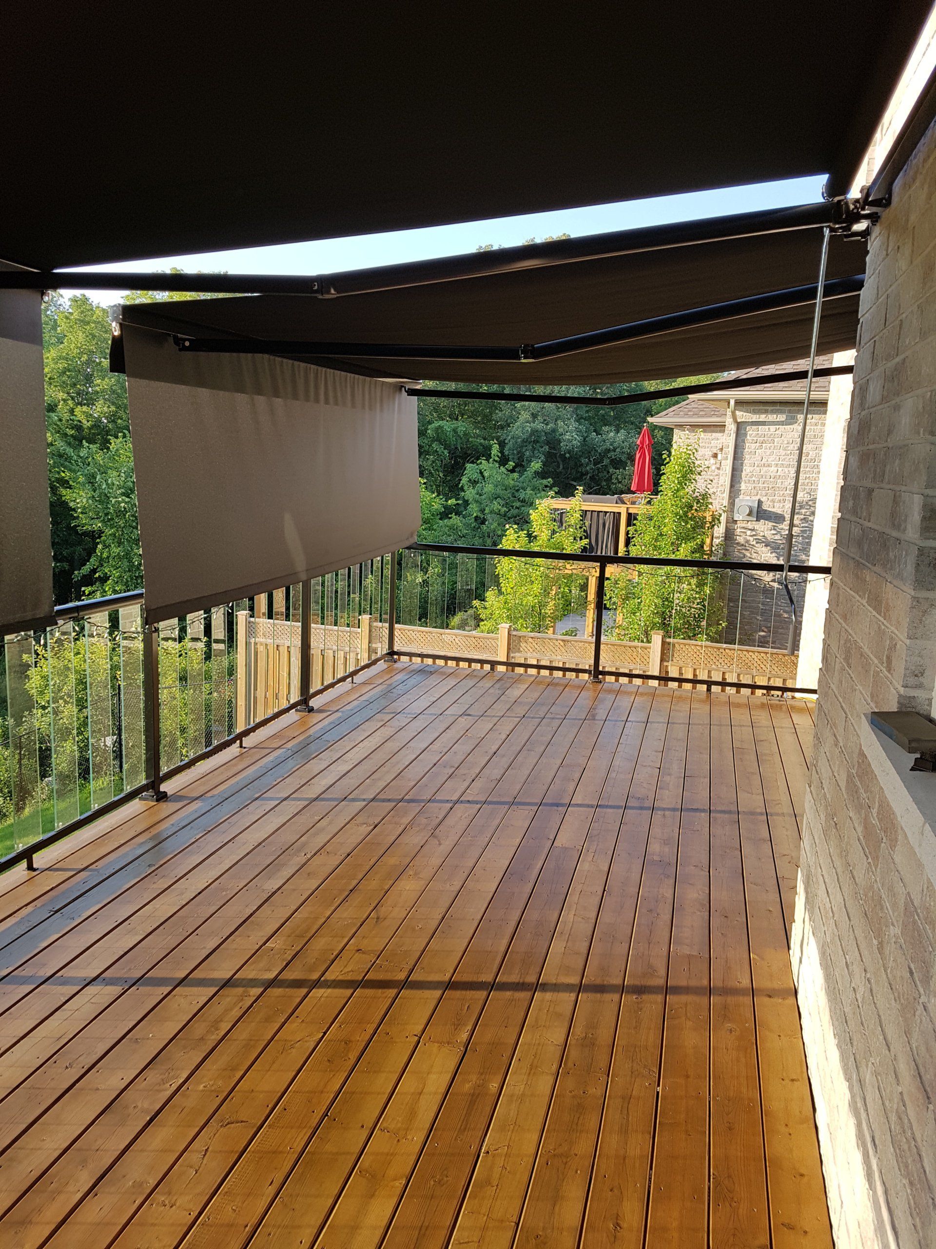 A wooden deck with an awning over it