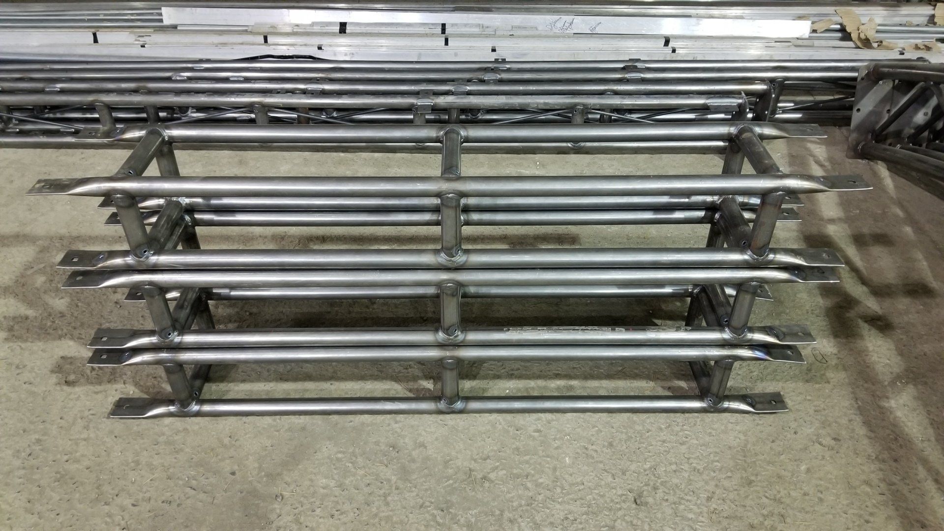 A stack of metal bars sitting on top of a cement floor.
