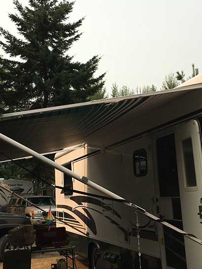 happy client's roll up awning on their RV after they installed it