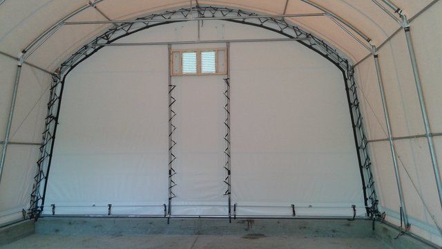 WHITE FABRIC END WALL OF A COVER-TECH HEAVY TRUCK PORTABLE GARAGE SHELTER TOLL FREE: 1 888 325-5757