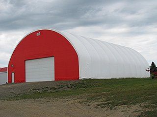 A red and white building with a large garage door