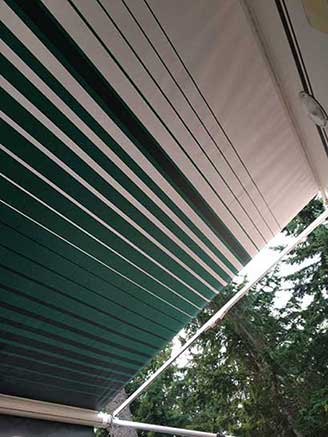 happy client's roll up awning on their RV after they installed it