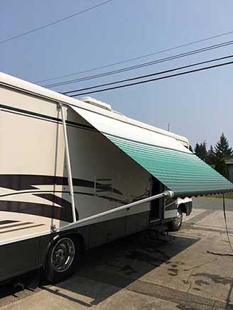 happy client's roll up awning on their RV after they installed it
