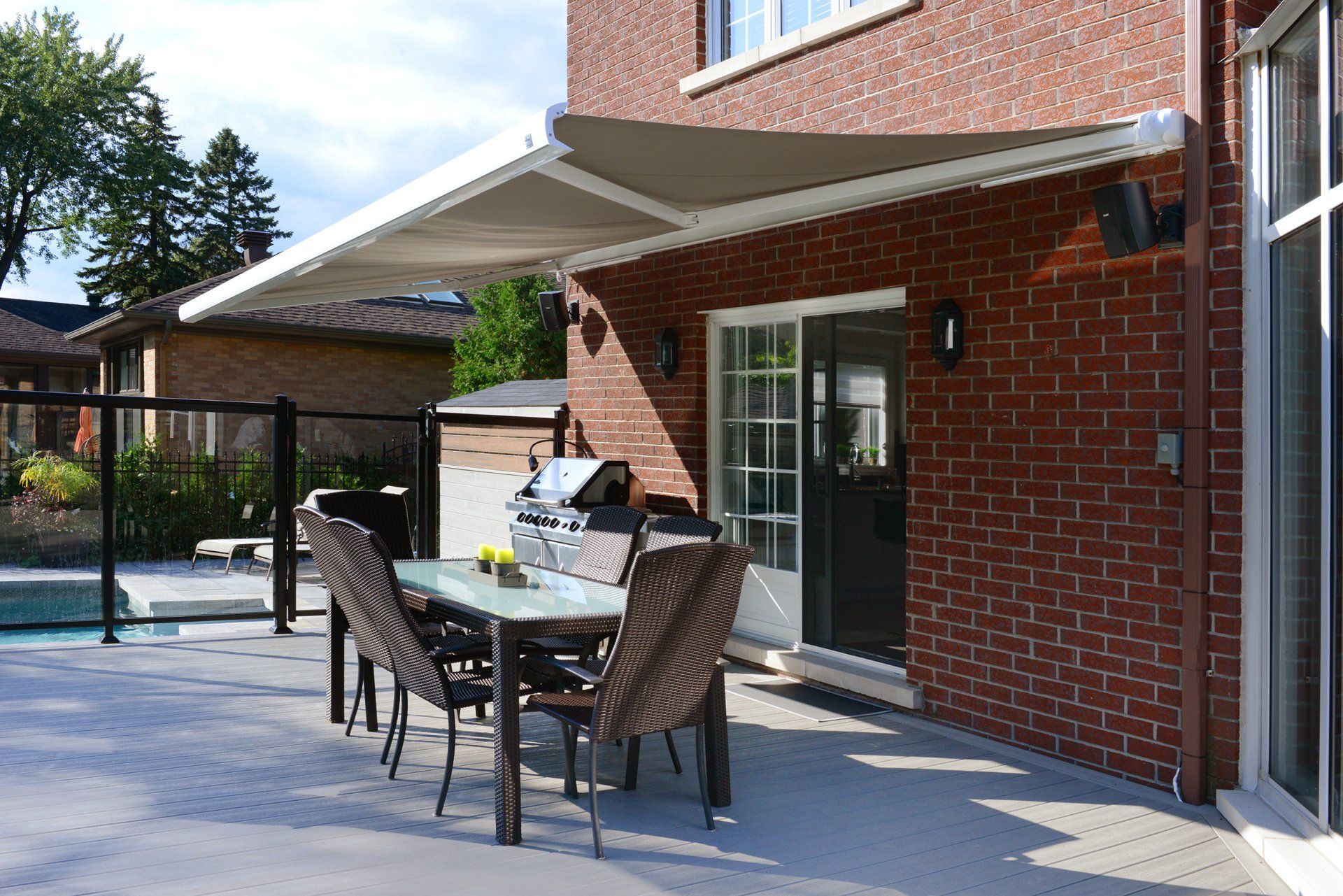 A patio with a table and chairs under an awning