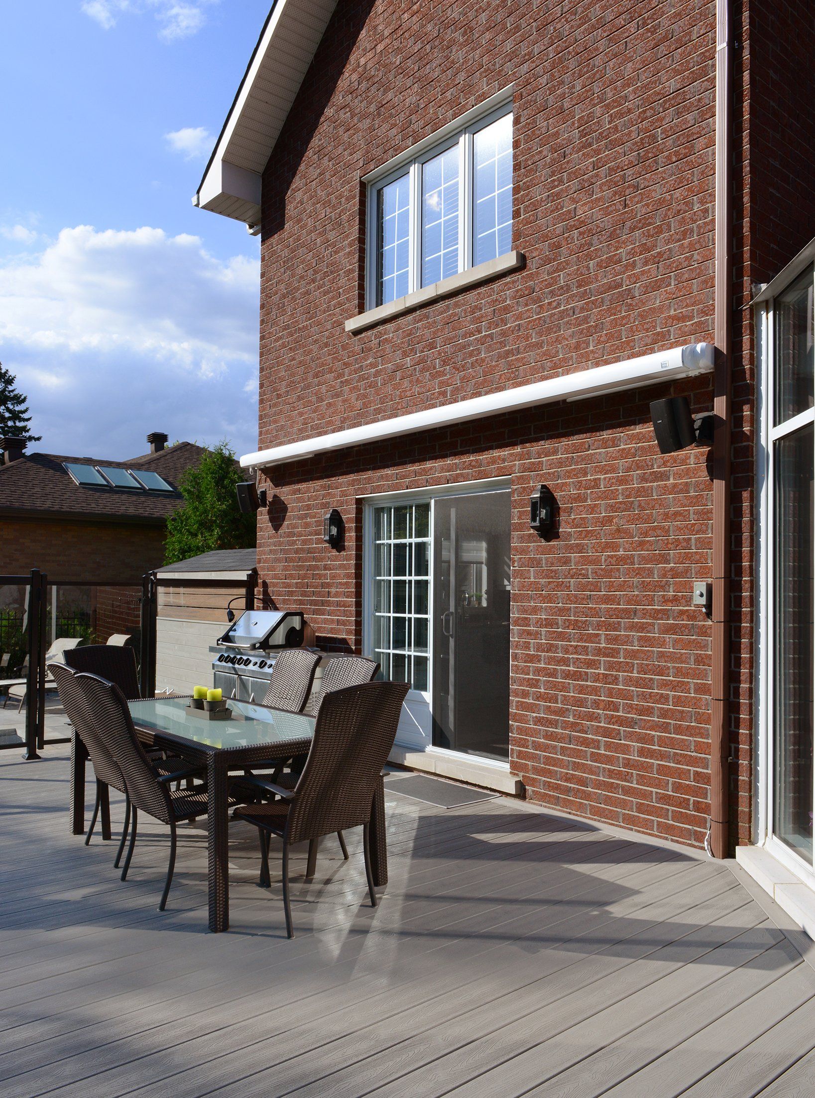 A brick house with a table and chairs outside