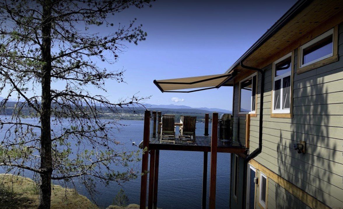 A house with a balcony overlooking a body of water