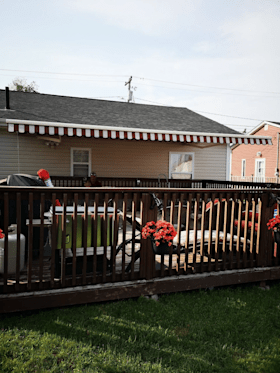 A house with a wooden deck and flowers on it