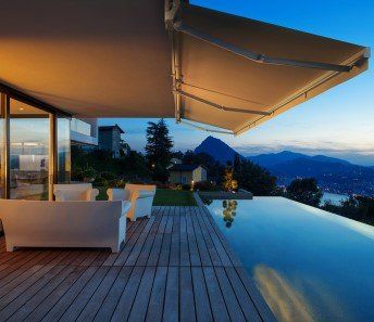A house with a swimming pool and an awning over it