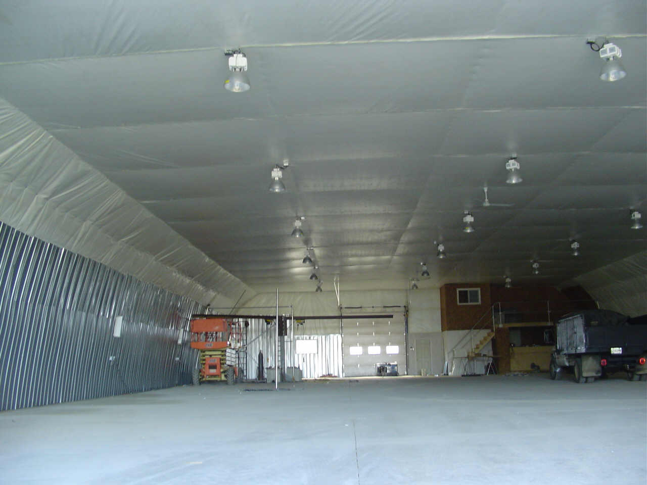 Picture of the inside of our 72' x 160' Gothic style welding shop with insulated wall liner and cover.
