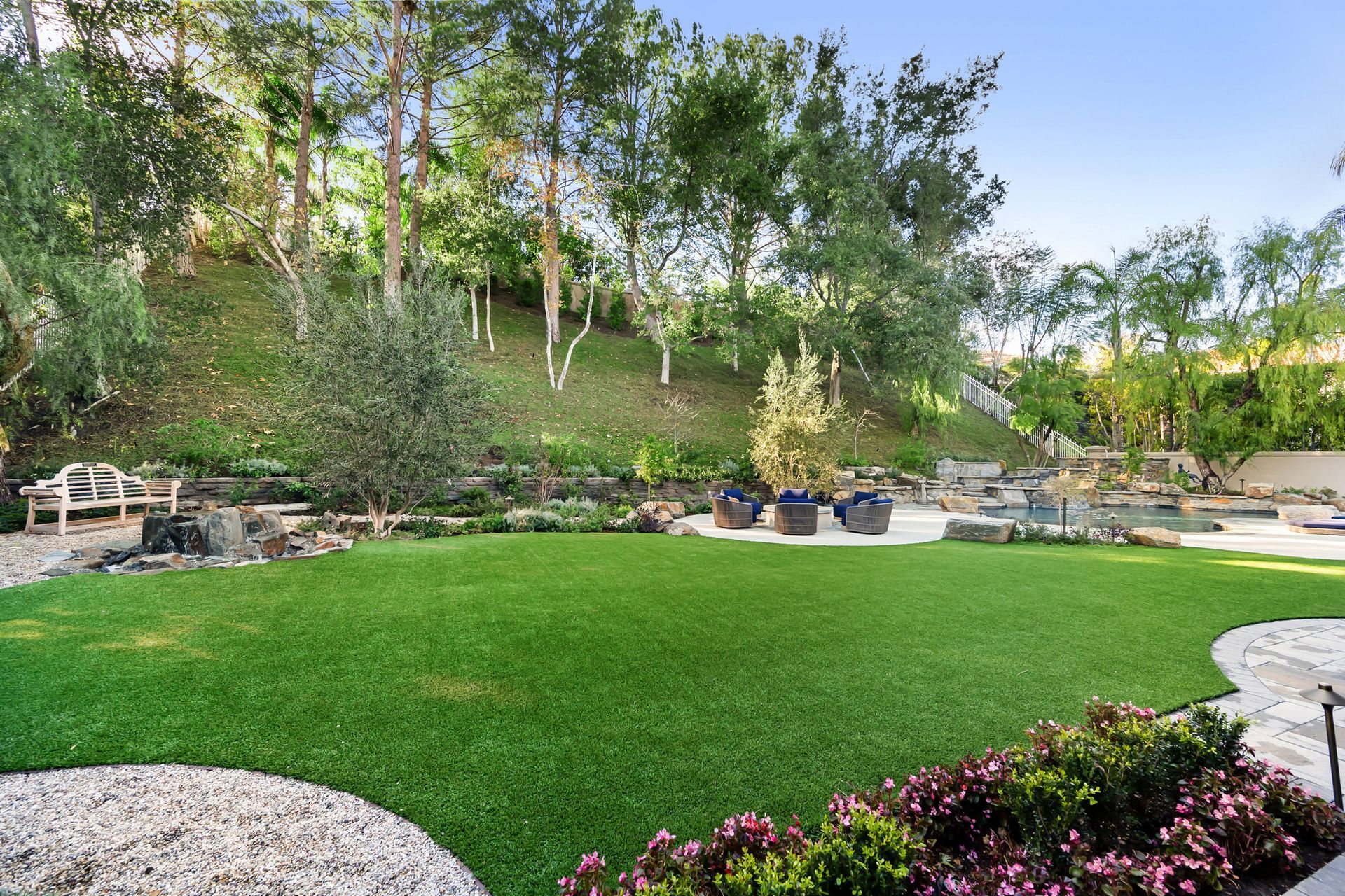 A Large Lush Green Lawn with Trees in The Background