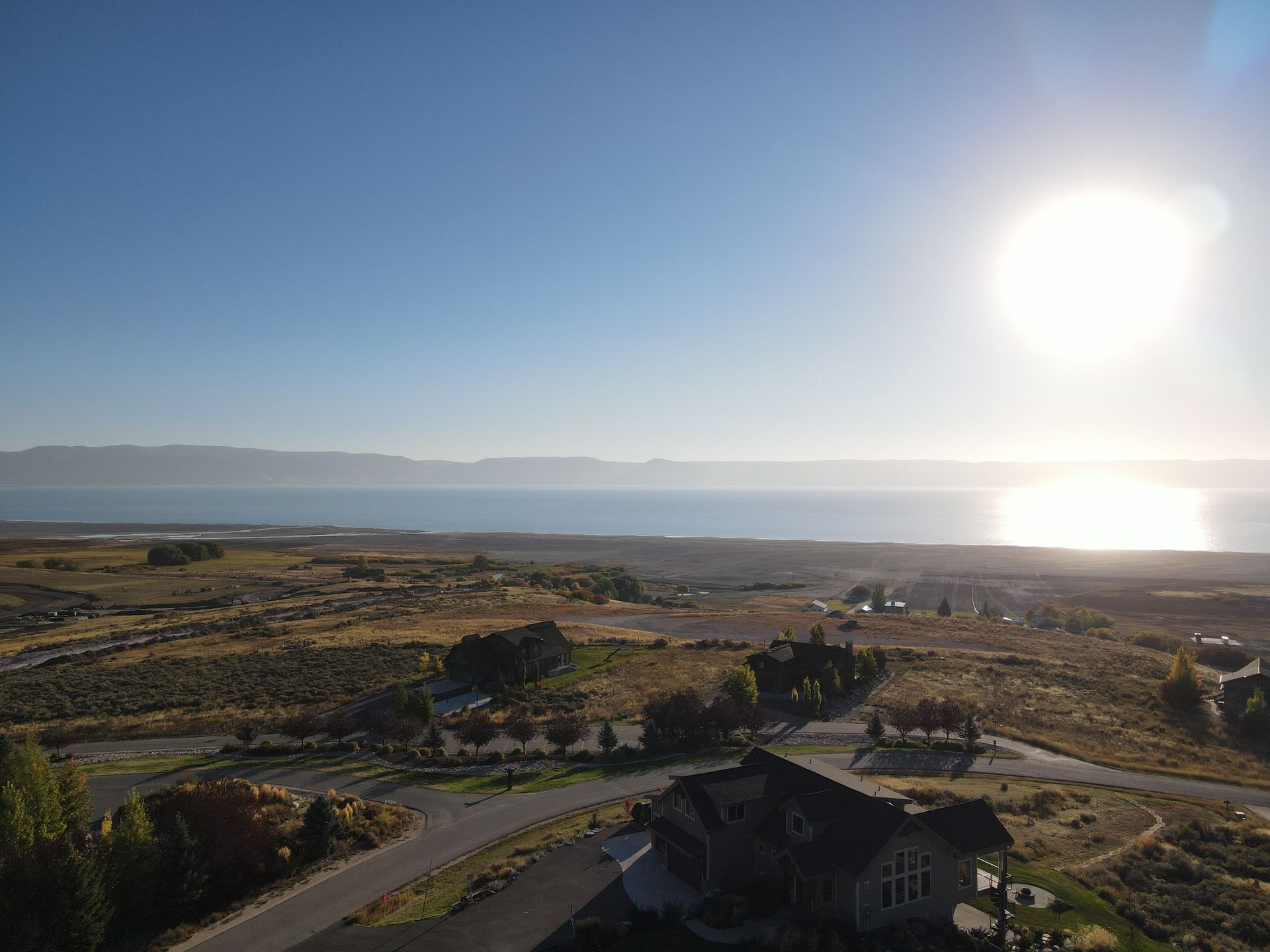 An Aerial View of A Residential Area with A Lake in The Background