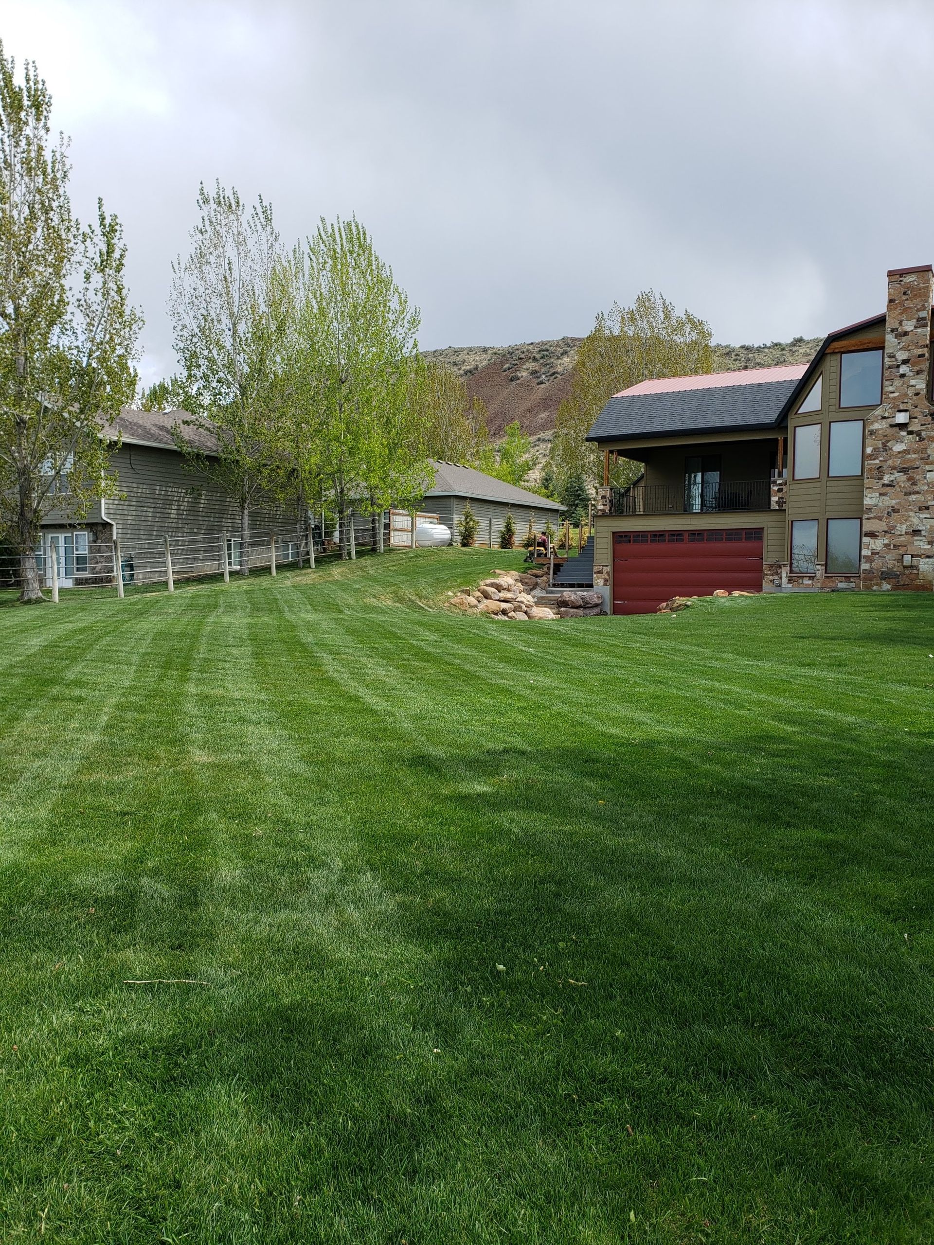 A Large Lush Green Lawn in Front of A House.