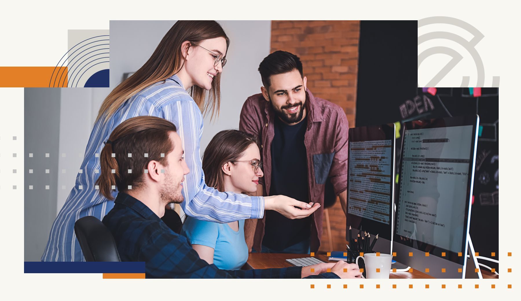 A group of people are sitting around a table looking at a computer screen.