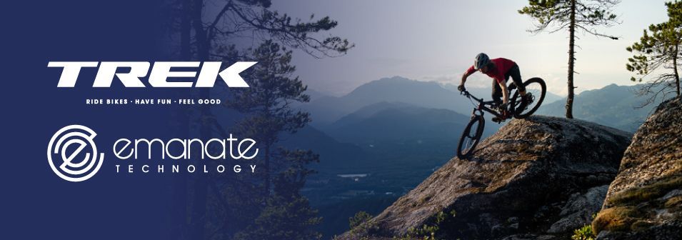 A man is riding a bike on top of a mountain.