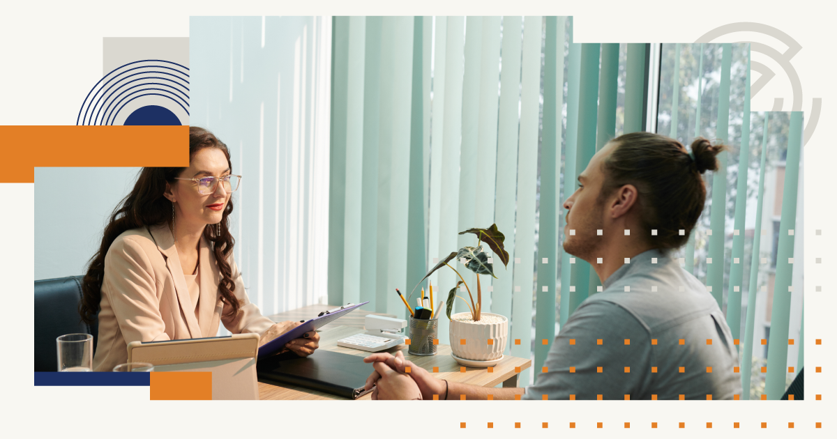 A man and a woman are sitting at a table having a conversation.