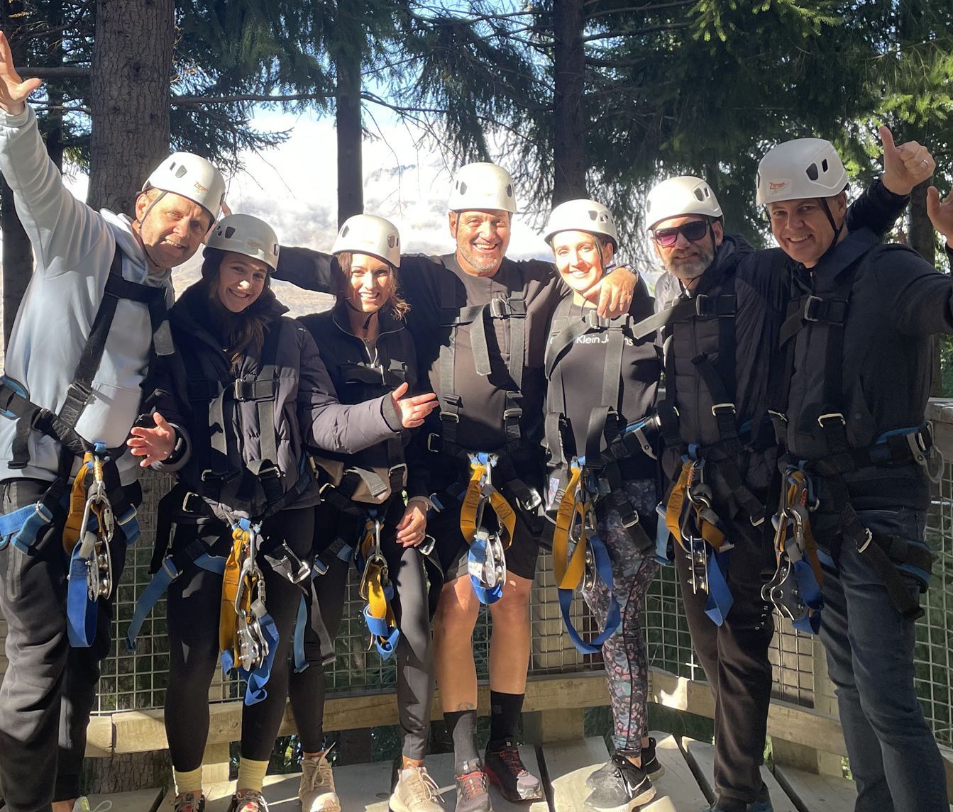 A group of people wearing helmets are posing for a picture