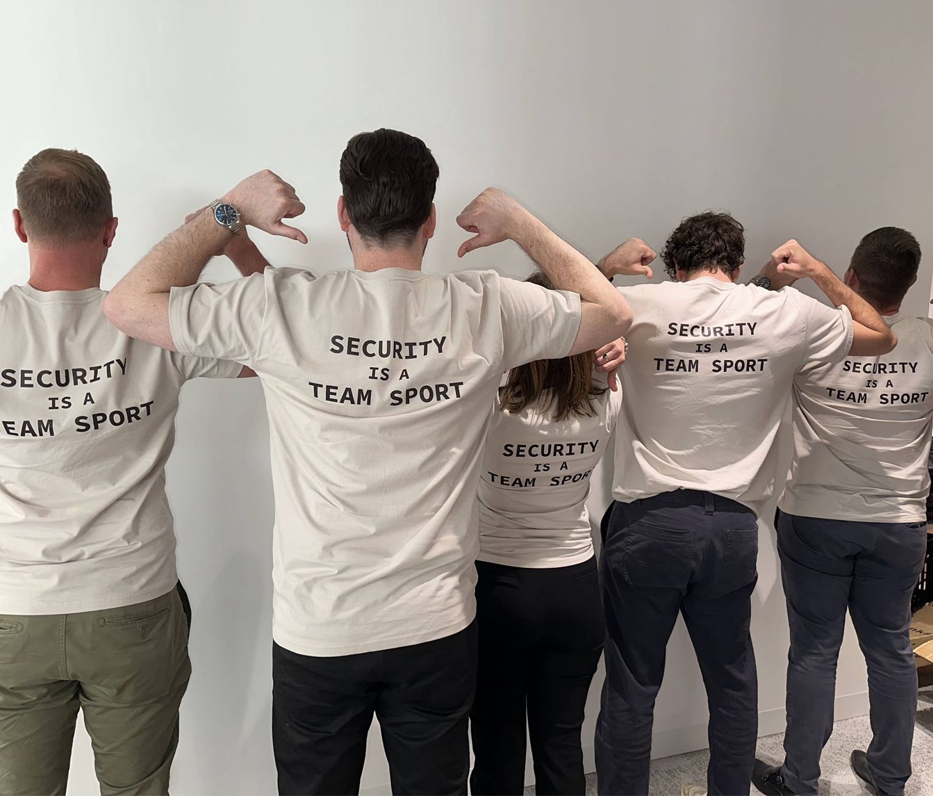 A group of people wearing shirts that say security is team sport