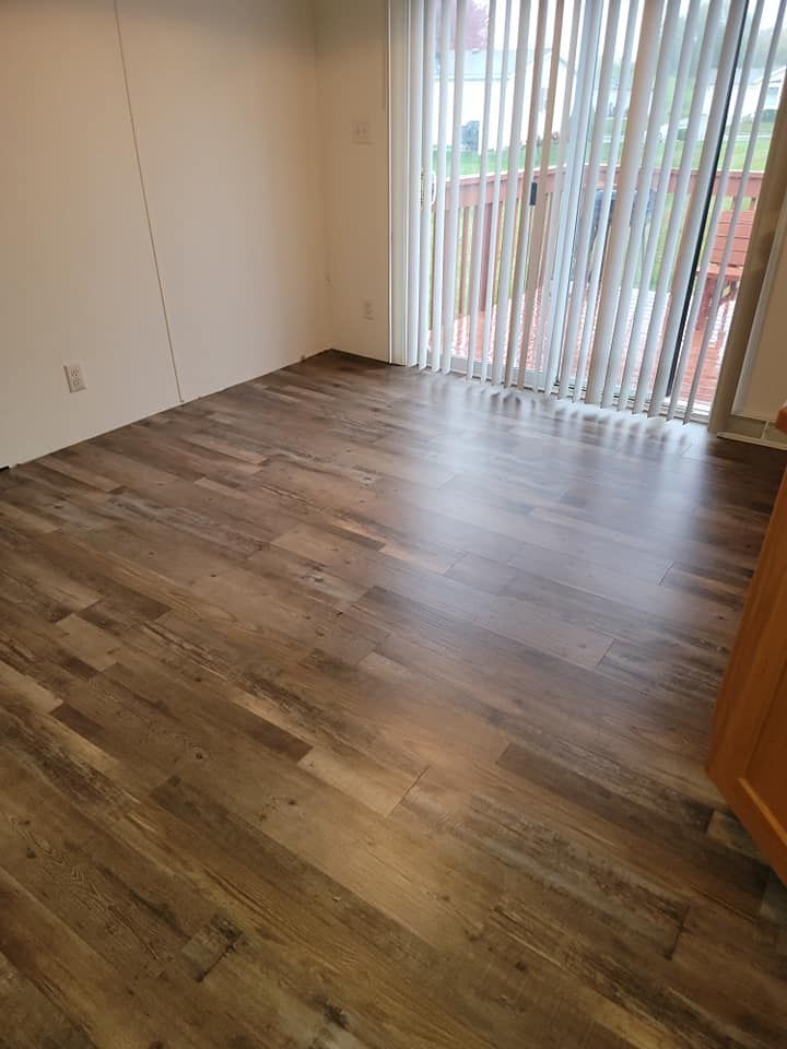 A living room with hardwood floors and a sliding glass door.