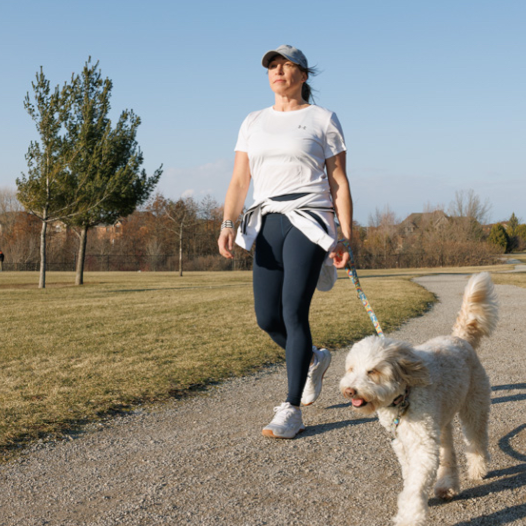 women walking outside with her dog.
