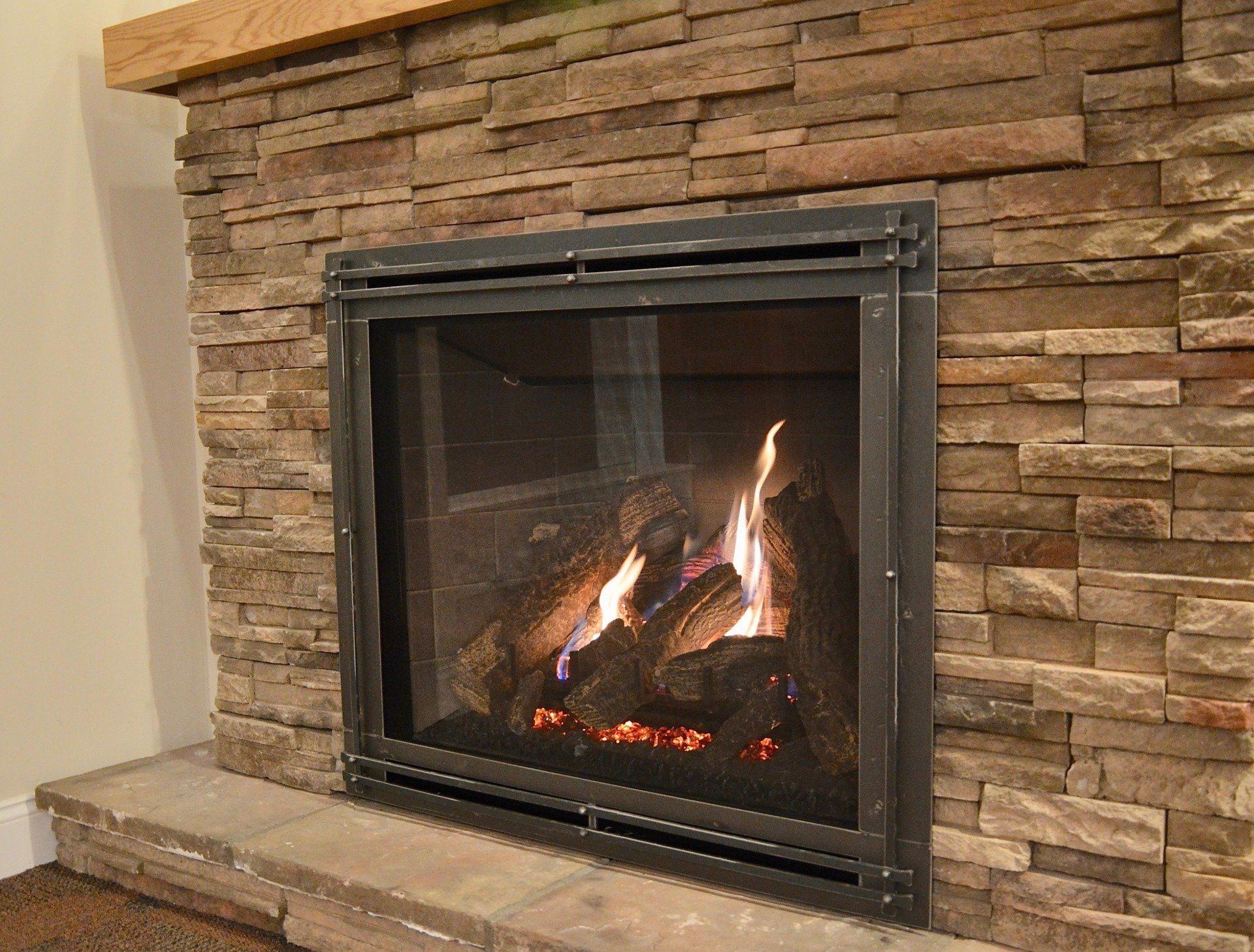 Propane Fireplace with Dark Stone Features in Albany, NY
