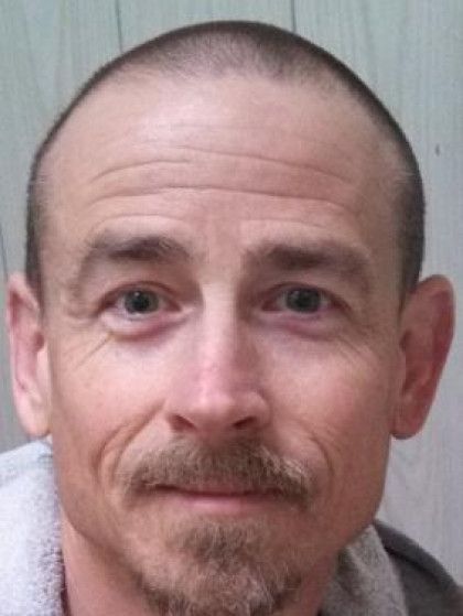 Man with short hair and goatee, looking at the camera.