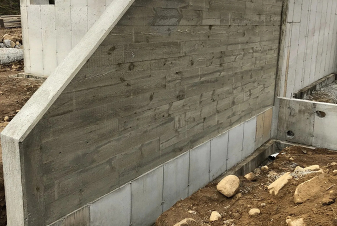 A concrete wall with stairs going up it is being built.