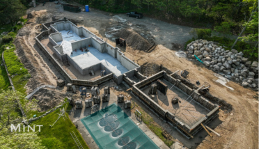 An aerial view of a house under construction with a pool.