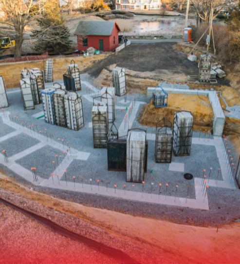 An aerial view of a model of a city with a red house in the background