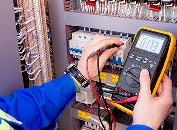 Electrical Contractor — Electrician Using Multi meter in Clinton, MO
