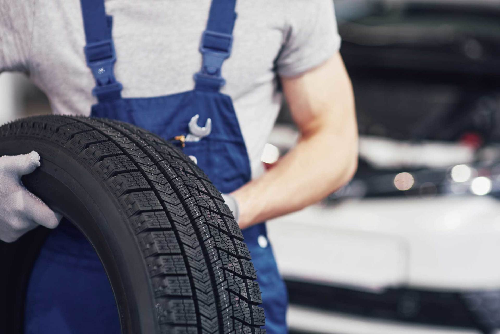 Tire Installation — Man Replacing a Tire in Charlotte, NC