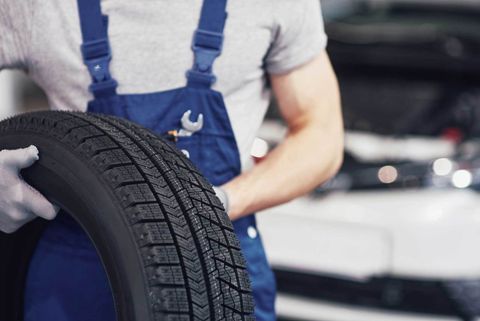 Tire Installation — Man Replacing a Tire in Charlotte, NC