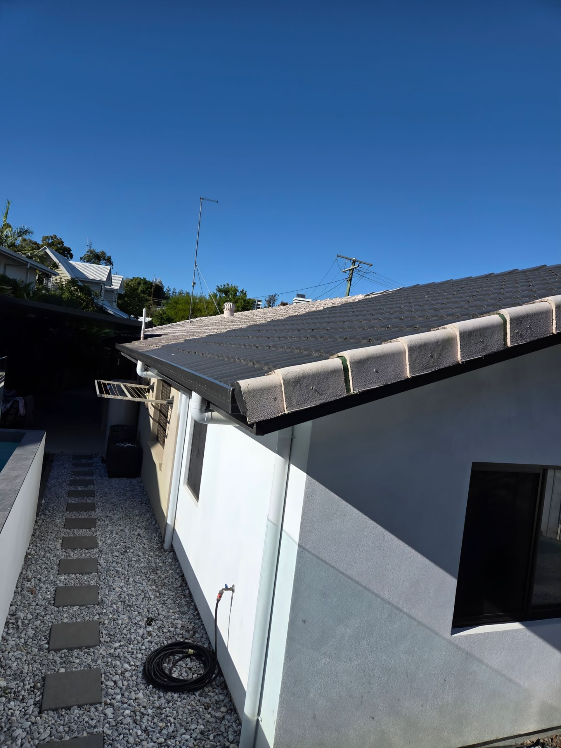 Exterior of Building With Dark Roof Tiles, Clear Blue Sky Overhead — MVP Painting Professionals in Sunshine Coast, QLD
