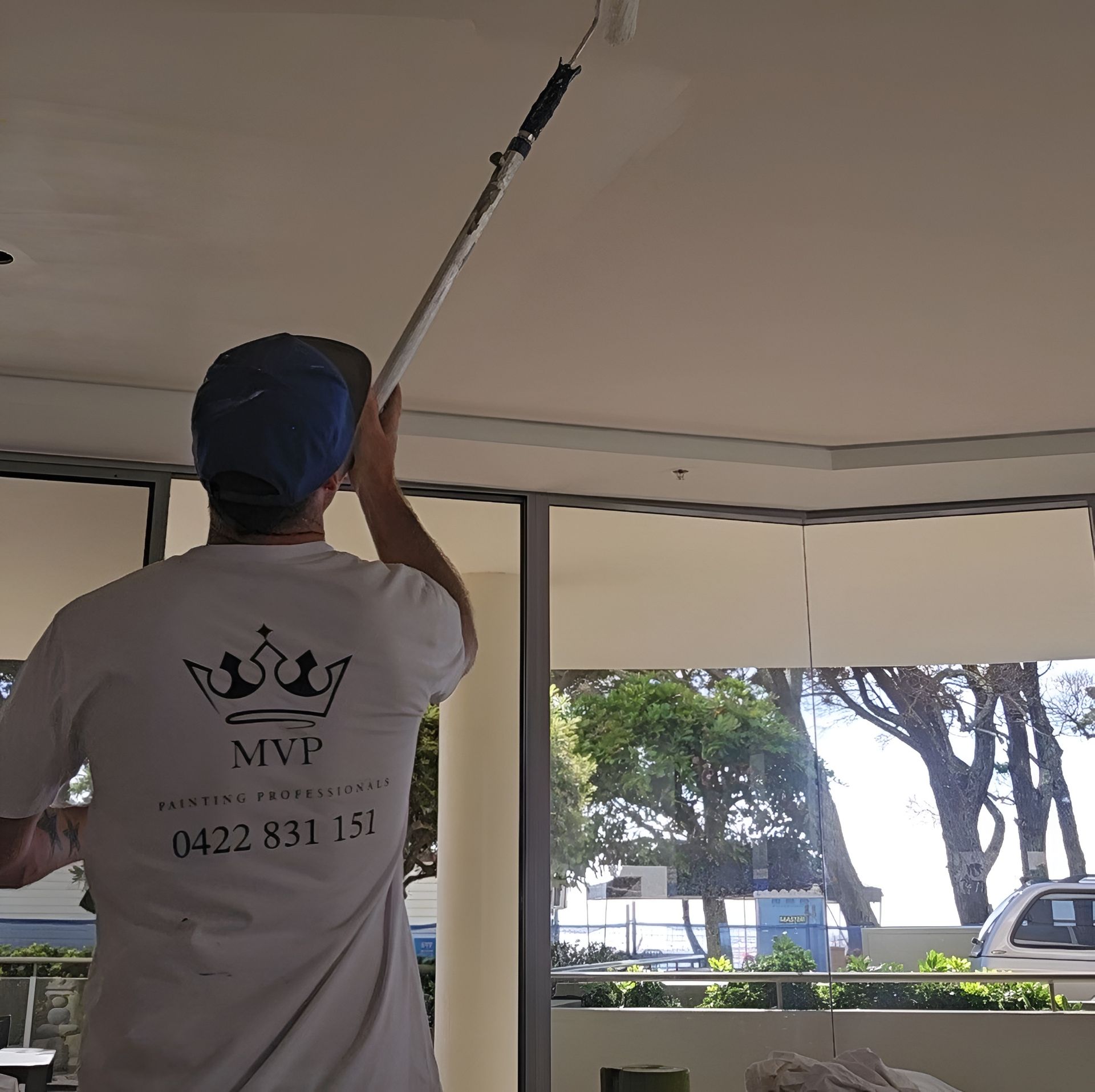 Person Painting a Ceiling With a Roller, Using a Long Pole — MVP Painting Professionals in Noosa, QLD