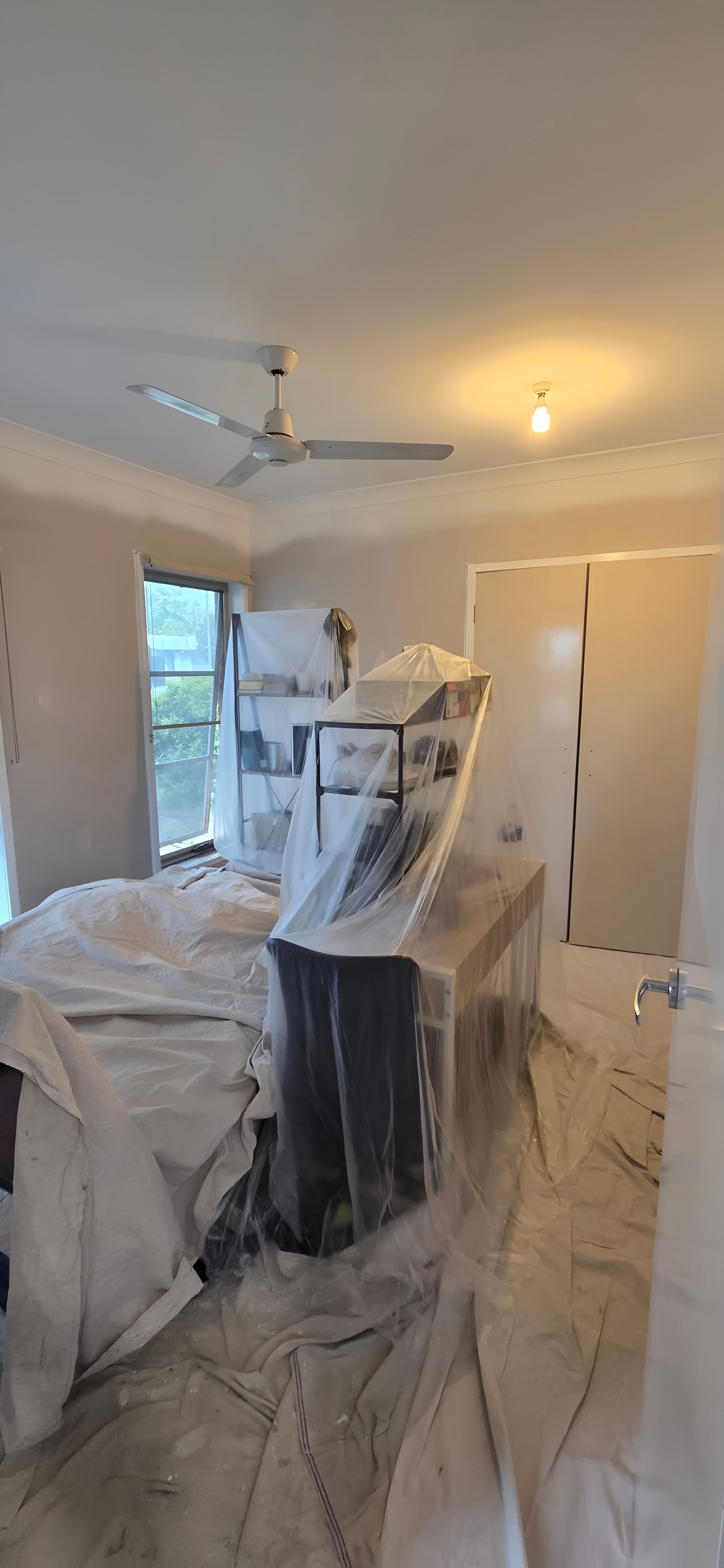Room in the Middle of a Renovation, Covered Furniture, Ceiling Fan, and Window — MVP Painting Professionals in Buderim, QLD