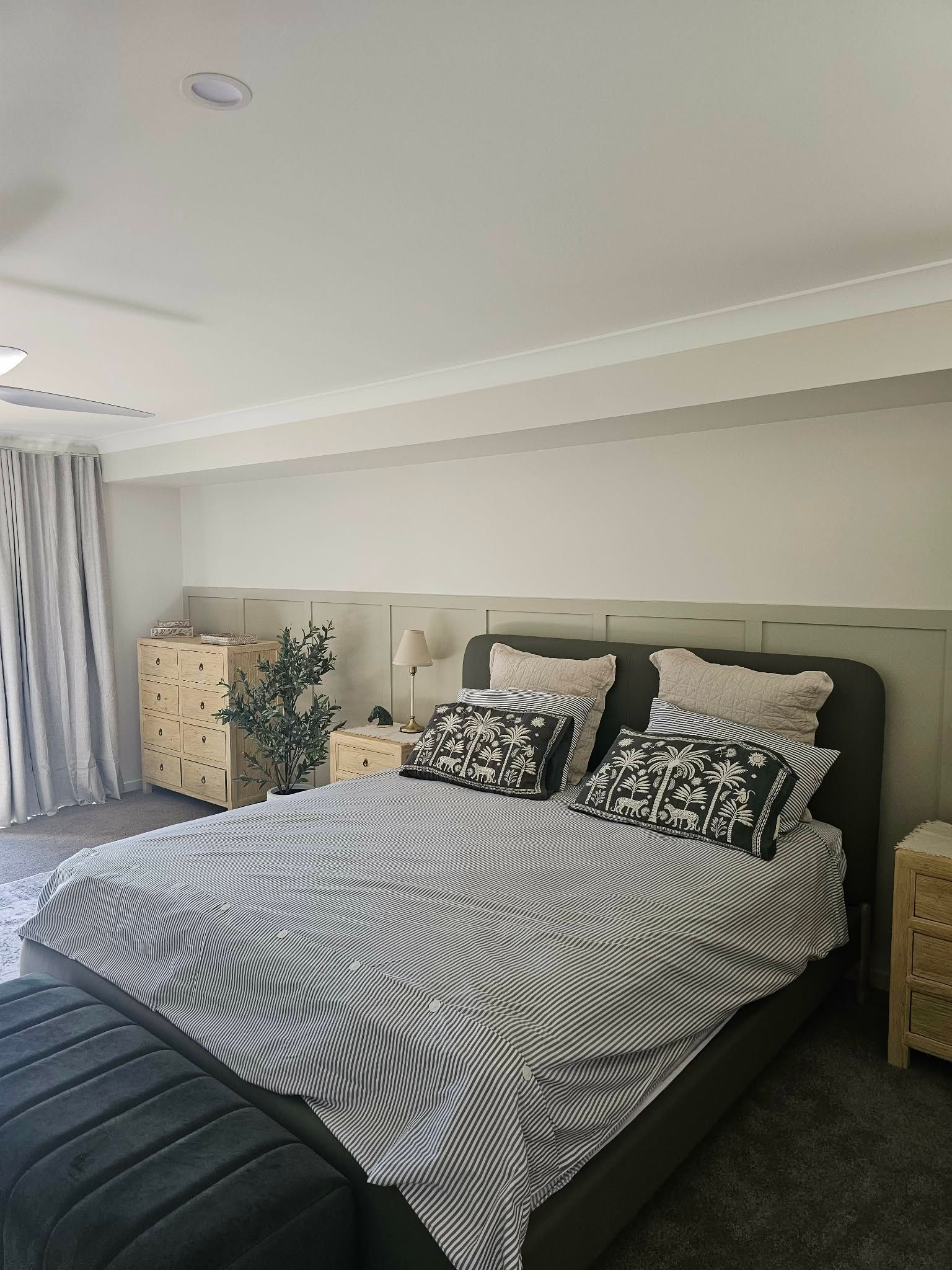 Bedroom with bed, patterned bedding, decorative pillows — MVP Painting Professionals in Buderim, QLD