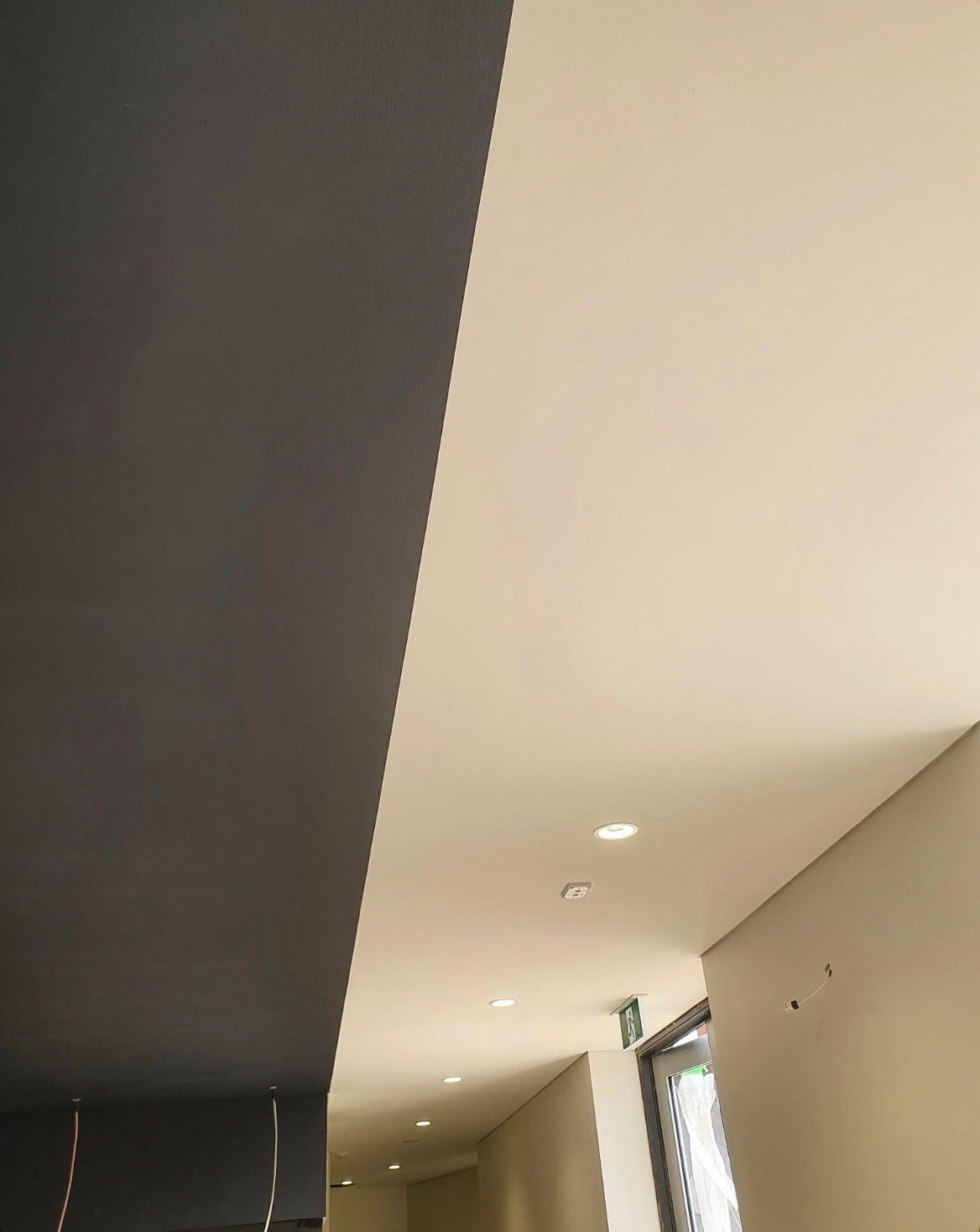 Ceiling with two contrasting colors, dark gray and off-white, above a hallway — MVP Painting Professionals in Sunshine Coast, QLD