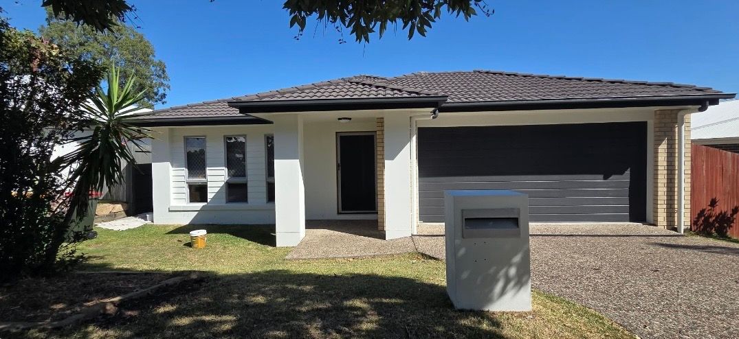 White house with Dark Gray Tiled Roof With a Black Trim — MVP Painting Professionals in Landsborough, QLD