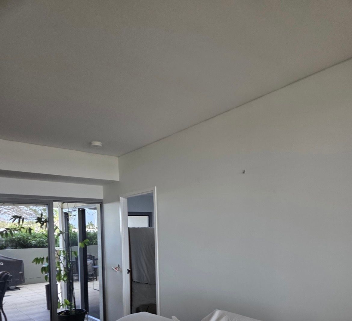 Interior of a room with white walls, ceiling, and an open door to a patio — MVP Painting Professionals in Kawana, QLD
