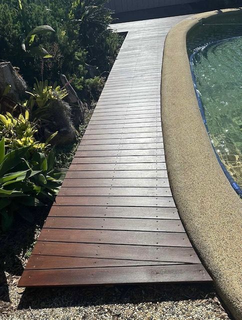 Wooden walkway next to a pool with light-coloured coping — MVP Painting Professionals in Nambour, QLD