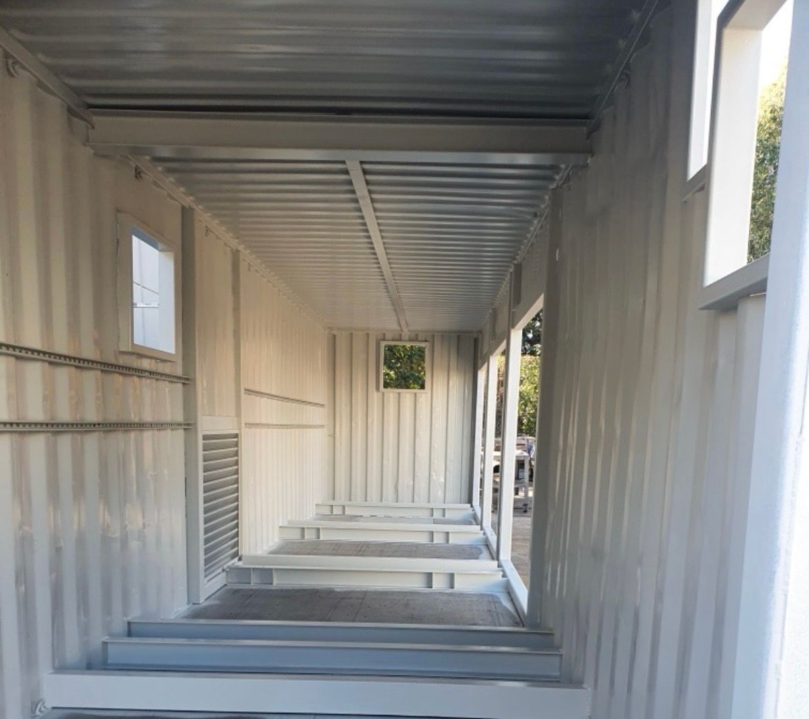 Interior of a white container with windows. Metal beams and walls — MVP Painting Professionals in Coolum, QLD