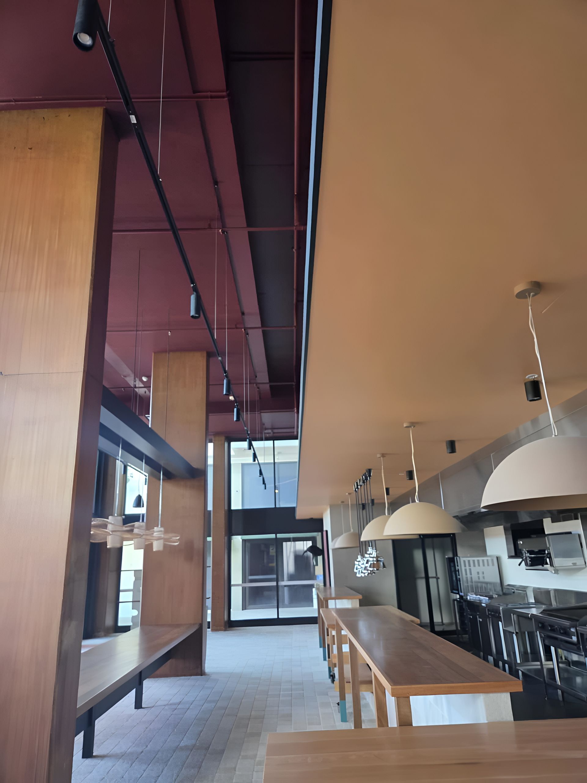 Warehouse With Closed Blue Doors and Red Awnings, on a Cloudy Day — MVP Painting Professionals in Caloundra, QLD