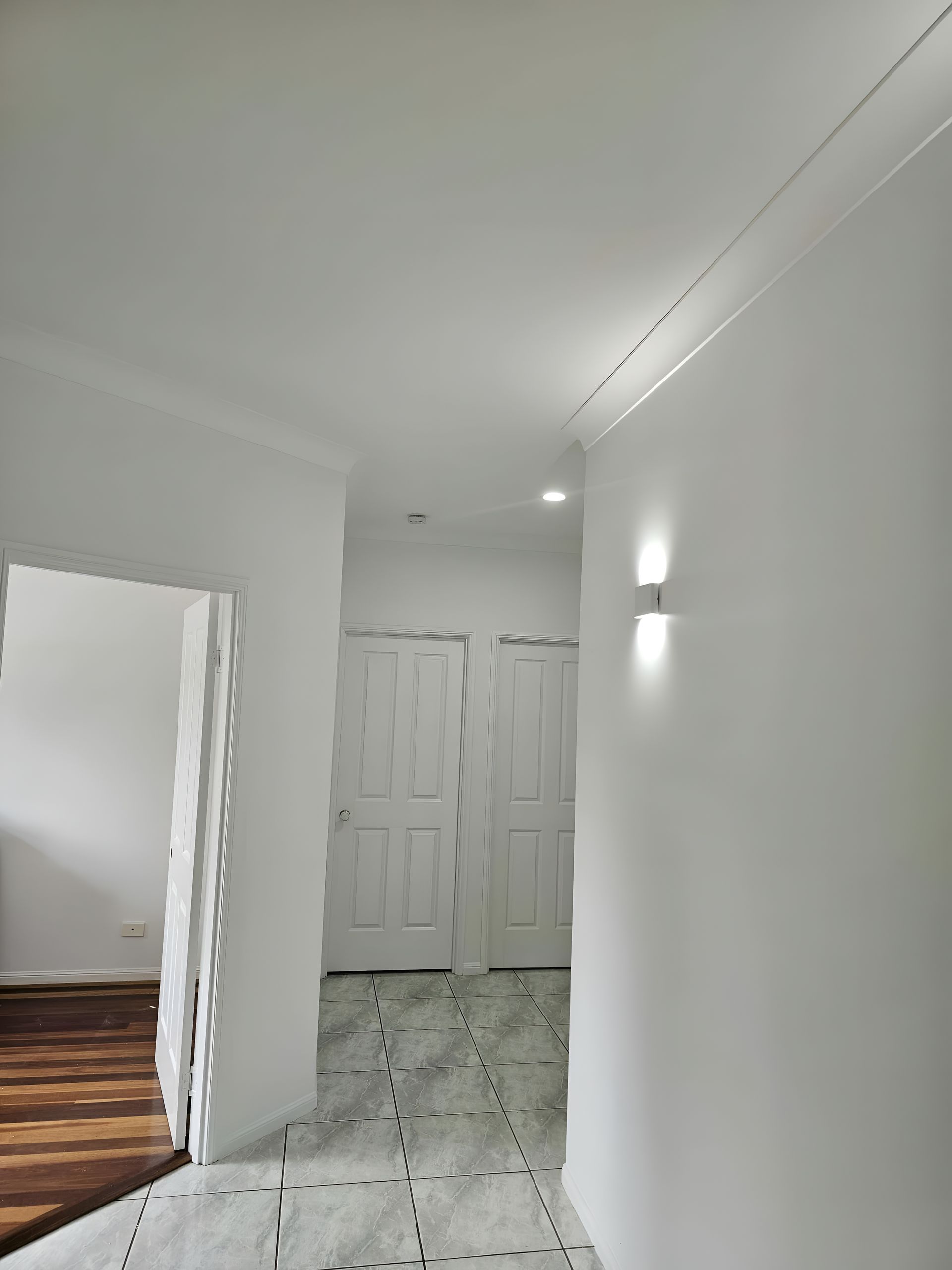 Hallway With White Walls, Doors, and Trim — MVP Painting Professionals in Nambour, QLD