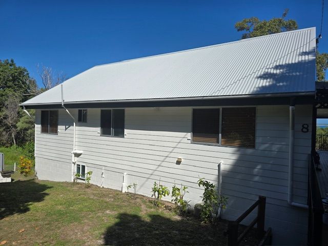 A white, single-story house with a grey corrugated metal roof — MVP Painting Professionals in Sunshine Coast, QLD