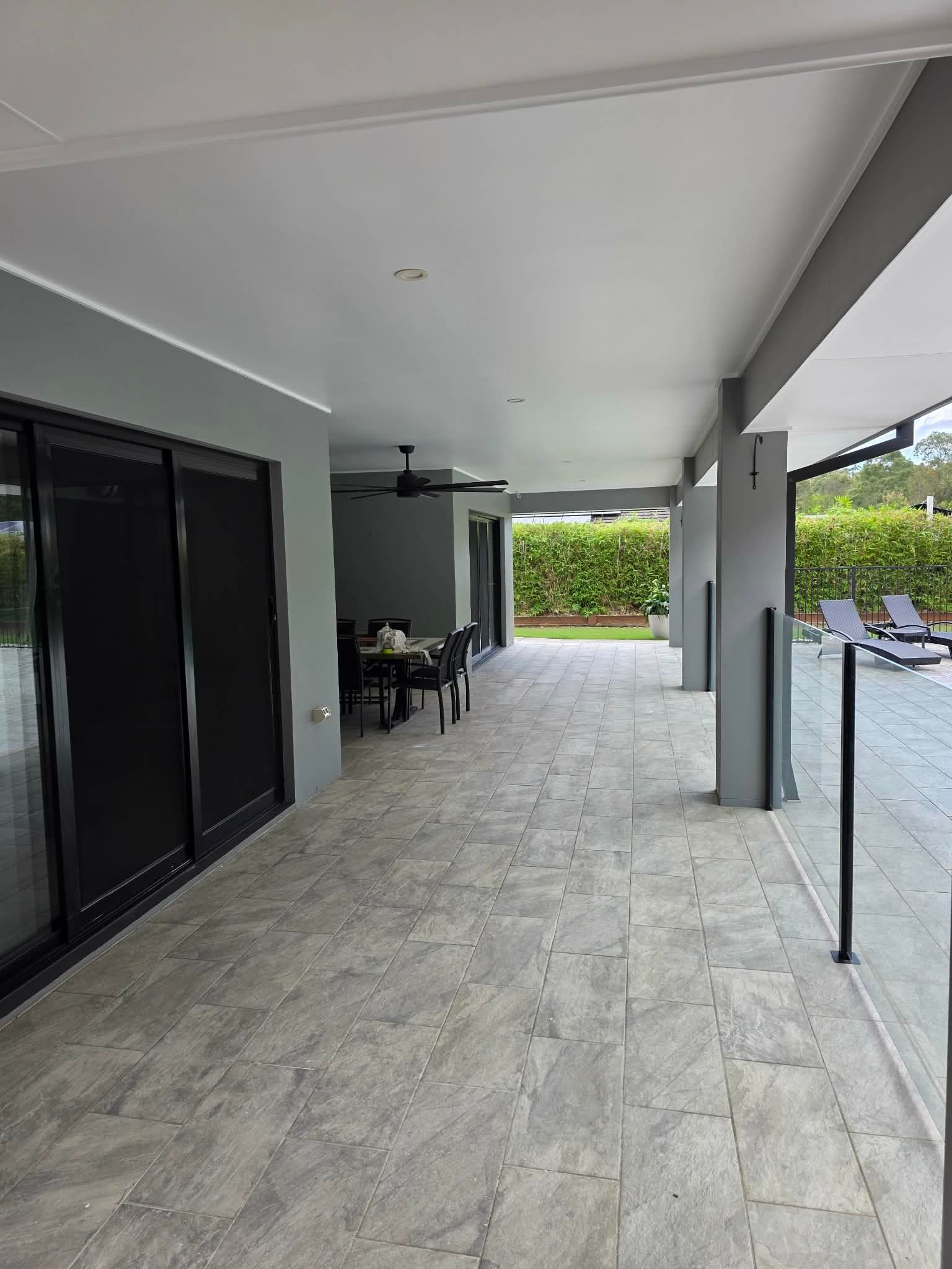 A Wide Covered Patio With Grey Tiled Floors — MVP Painting Professionals in Sunshine Coast, QLD