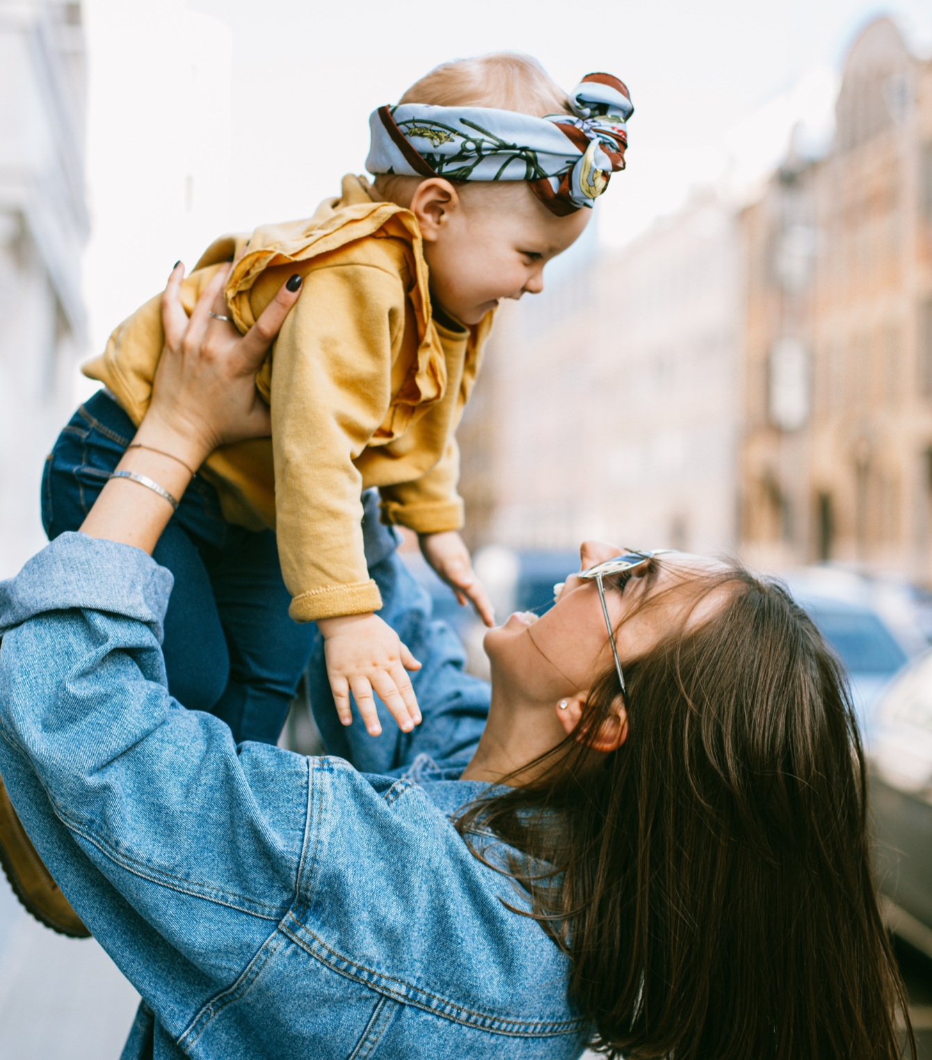 A woman is holding a baby in her arms.