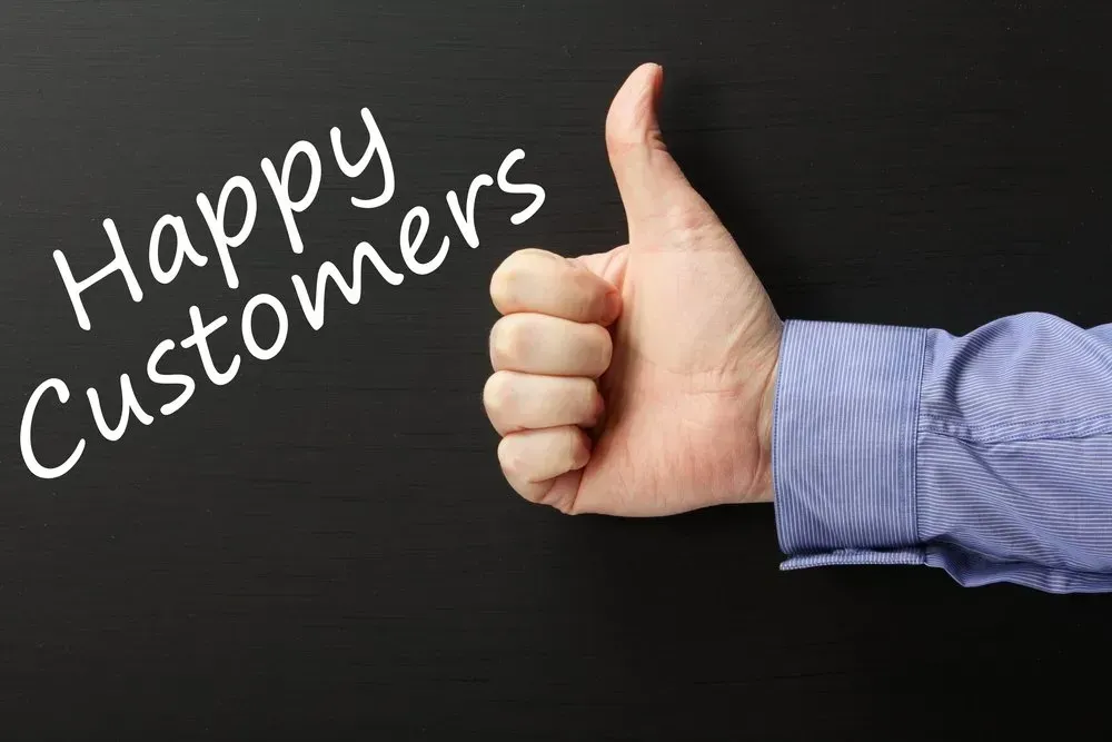A hand is giving a thumbs up in front of a blackboard that says `` happy customers ''.