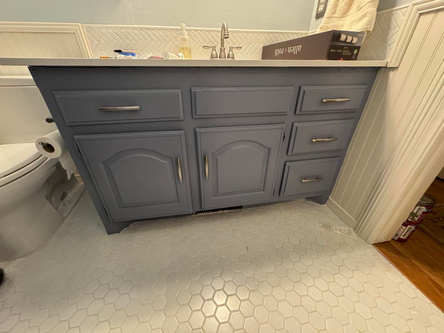 Family gathered at a dining table in a kitchen. They are eating and talking together.