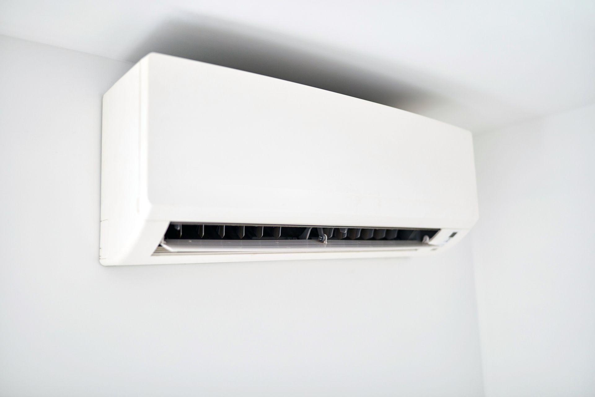 Newly installed ductless mini split AC unit inside a modern living room by Comfort Control.
