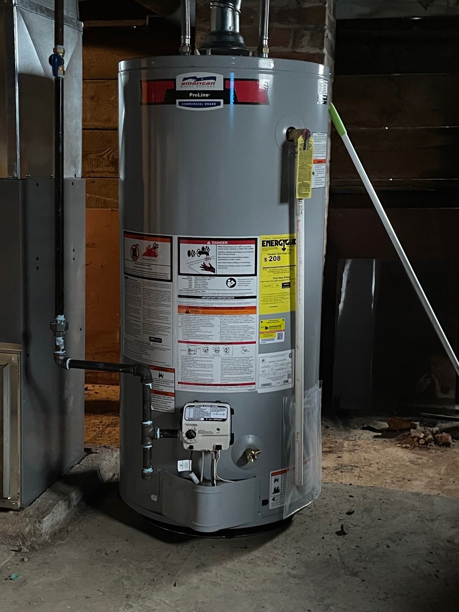 A person is adjusting the temperature of a water heater.